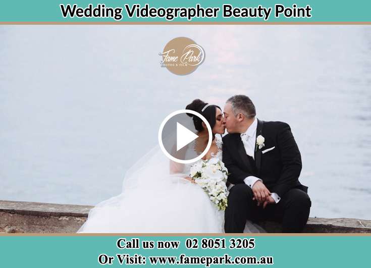 Bride and Groom kissed near the shore while sitting Beauty Point NSW 2088