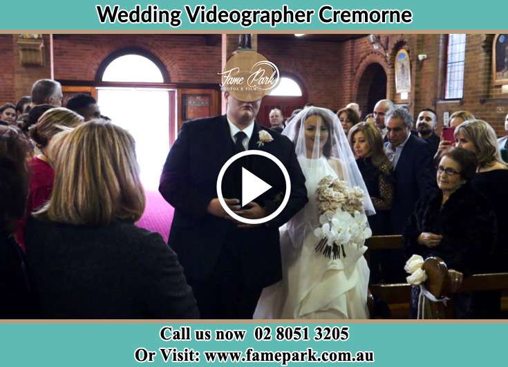 Bride holding a bouquet of flowers with the Groom while walking in the aisle Cremorne NSW 2090