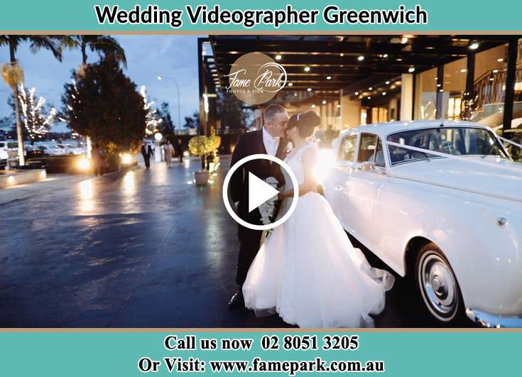 The new couple kissing near the wedding car Greenwich NSW 2065