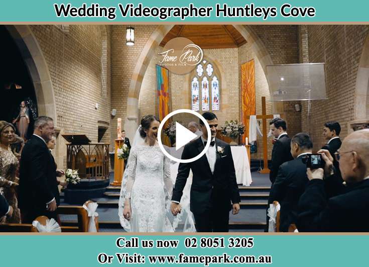 The newly weds walking through the well wishers Huntleys Cove NSW 2111