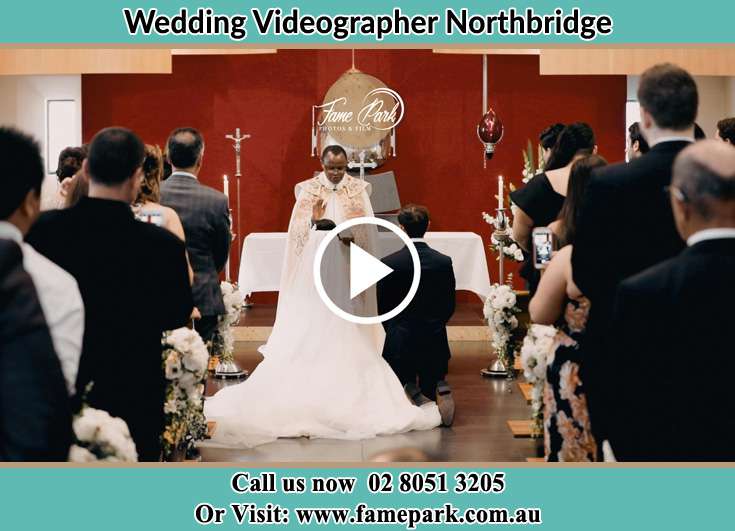 Bride and Groom kneel at the altar during the ceremony Northbridge NSW 2063